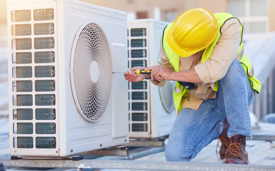 An HVAC technician in Youngstown, Ohio, works on a commercial air conditioning system.